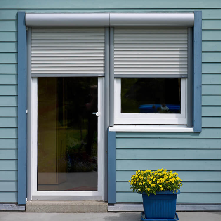 Front mounted roller shutter fitting position for a balcony door