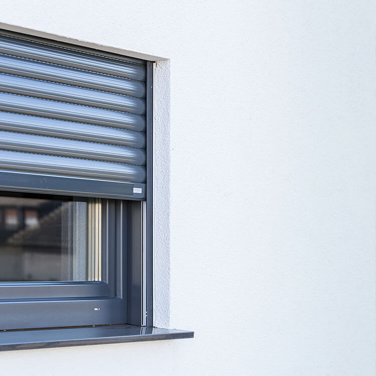 A top-mounted system with a roller shutter in anthracite grey